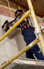 Man putting up drywall