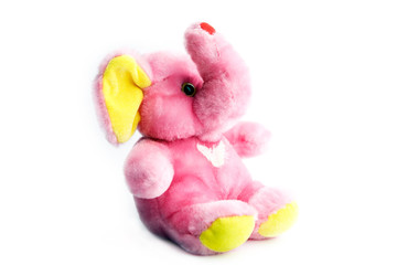 Yellow and pink soft elephant isolated over white.