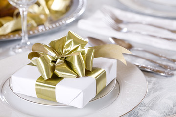 Elegant table set with present as focus