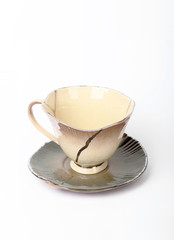 Broken clay cup isolated on a white background