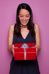 Fototapeta premium Woman happy as she receives a gift