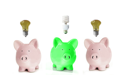 Piggy banks with light bulbs. One green.