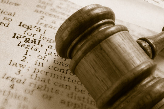 court gavel and legal definition, closeup from above