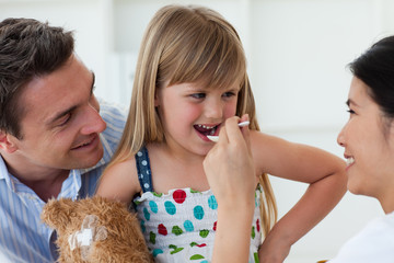 Smiling doctor giving medecine to a child