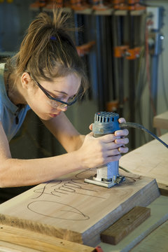 Young woman cabinet making.