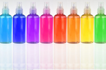 colored bottles with cosmetics in a row