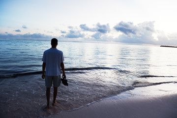 young man and sunset on Caribbean sea