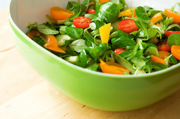 Fresh vegetable salad served in a green salad bowl