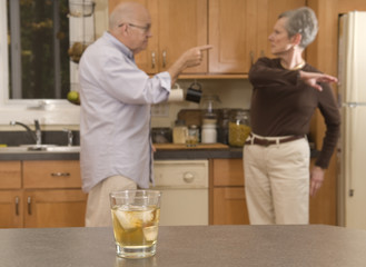 Senior couple drinking and having a fight