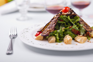 Salad from Eruca sativa, eggplants and tomatoes
