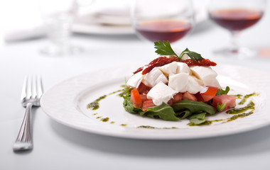 Dish with tomatoes, salad ruccola and cheese a Burrata