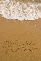Fototapeta premium Year 2010 written on the sand