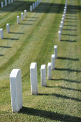 Cemetery with lots of gravestones in a row