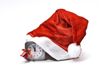 Santa cap on a clock and red bell