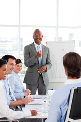 Confident Afro-American businessman discussing with his team