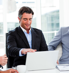 Fototapeta premium Portrait of a confident businessman using a laptop