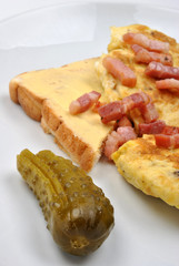 scramled eggs, gherkin and toast on a plate