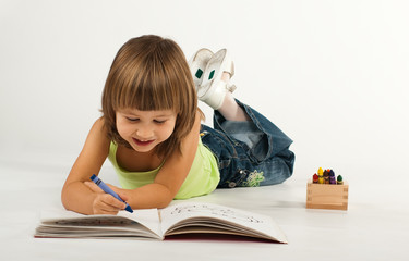 Cute little girl with drawing book