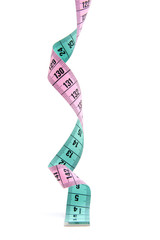 pink and green measure tape over white background