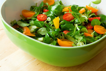 Fresh vegetable salad served in a green salad bowl