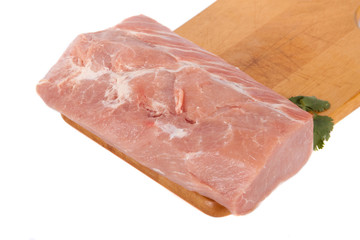 Fresh pork meat on wooden board with parsley