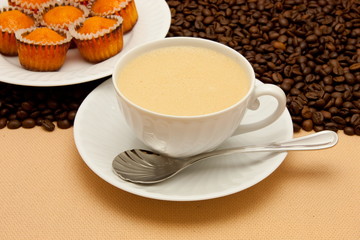 White cup of coffee and coffee beans