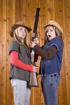girls and gun looking scared