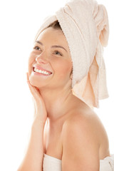 Portrait of happy woman wrapped towel