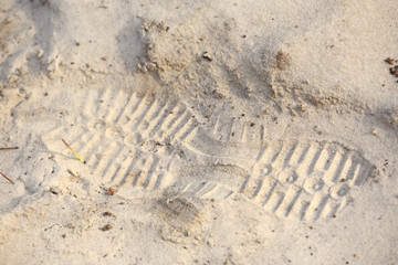Fototapeta na wymiar Trace from a footwear protector on sand