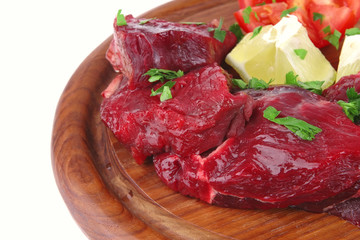 small beef chunks on wooden plate