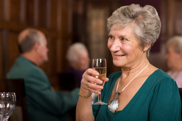 Happy senior lady in restaurant