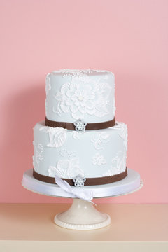 Two-tiered Cake Against Pink Background
