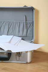 Aluminum suitcase with paper and copy space