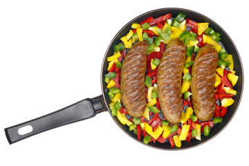 Pork sausage and paprika in a frying pan.