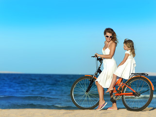 woman and girl  on the beach