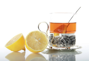 Tea in glass mug and lemons