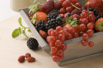 Mixed berries in a wooden basket.