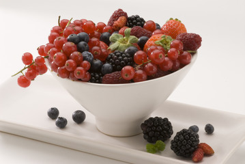 Mixed berries in a white bowl.