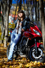 Fototapeta na wymiar The girl and red motorcycle