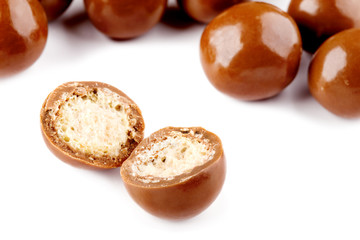 Chocolate balls and half with crisp filling isolated on white