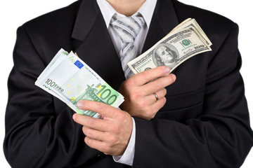 Businessman holding dollars and euros, isolated