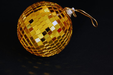 Golden ball on black closeup