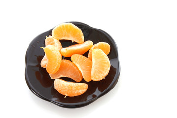 Fresh mandarin on the black  plate