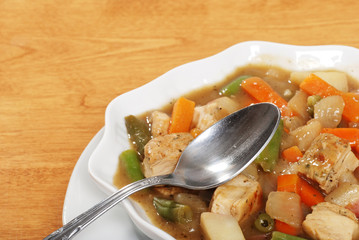 closeup chicken stew with a spoon