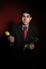 Young happy smiling handsome man with rose