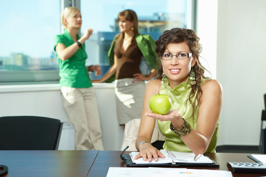 Businesswoman holding apple