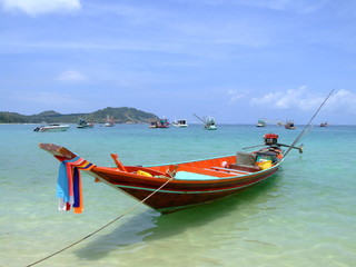 Fototapeta na wymiar Boat on a calm sea shore, Koh Phangan, Thailand.