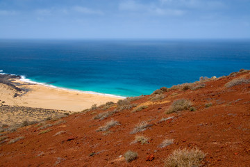 Sand beach under a red volcano in Lanzarote