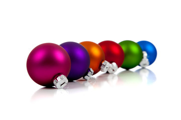 A row of assorted Christmas ornaments/baubles on white