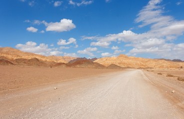 Road in the desert towards the distant rocks